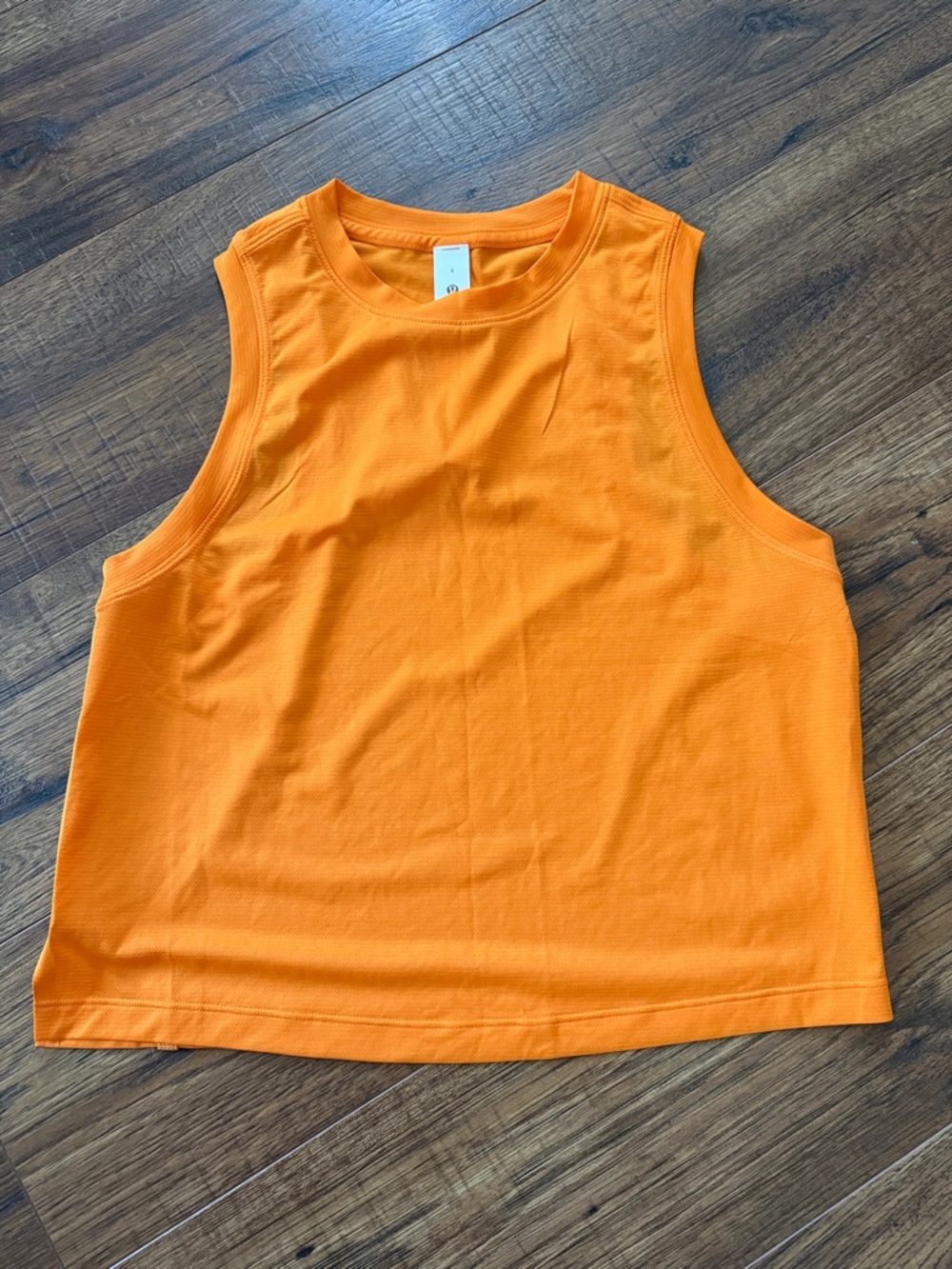 Lululemon Ultralight Waist-Length Tank Top in the color Lit Orange